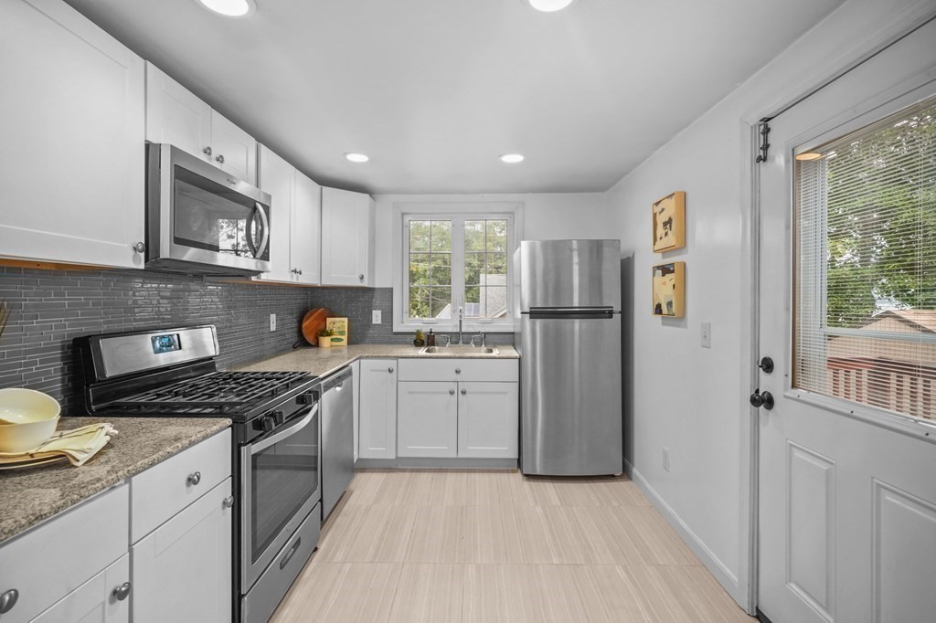 1122 Wood Street Fall River, MA 02721 - Photo 18 of 39 a kitchen with a refrigerator stove top oven and sink
