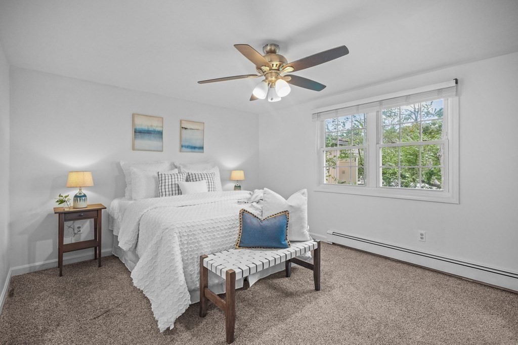 1122 Wood Street Fall River, MA 02721 - Photo 20 of 39 a bedroom with a bed and a chandelier