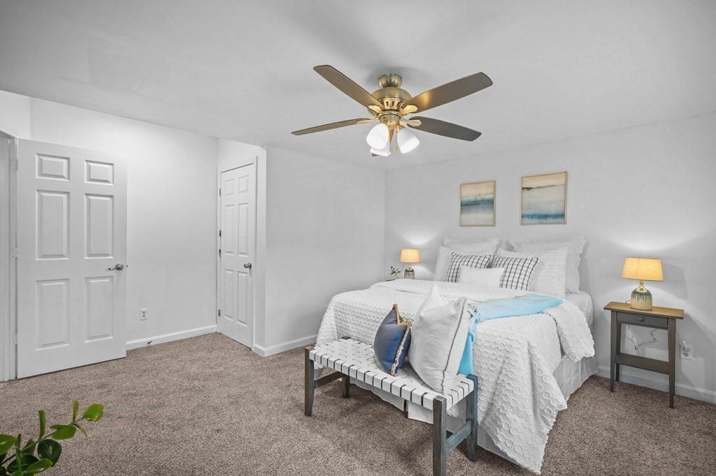 1122 Wood Street Fall River, MA 02721 - Photo 21 of 39 a bedroom with a bed and a chandelier