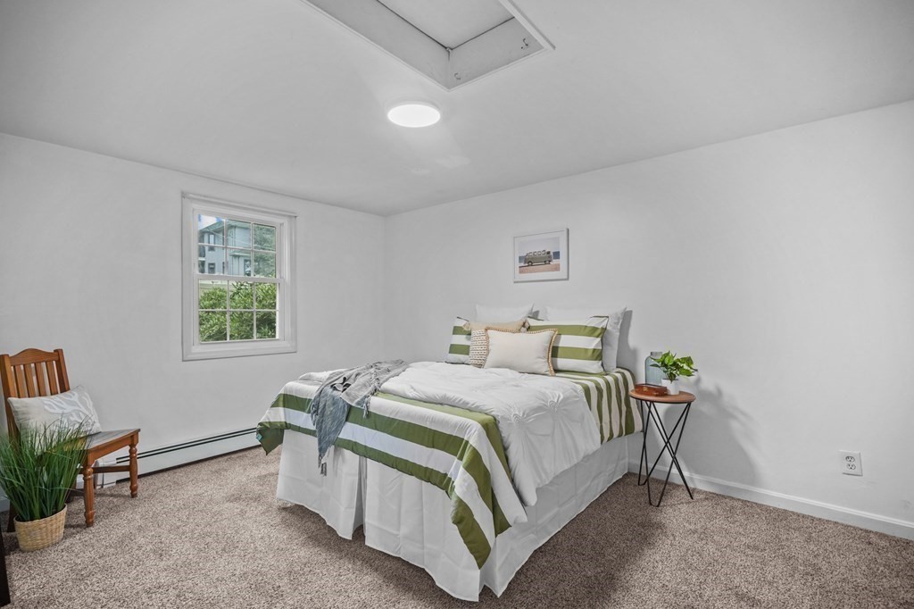 1122 Wood Street Fall River, MA 02721 - Photo 23 of 39 a bedroom with a bed table chair and a window