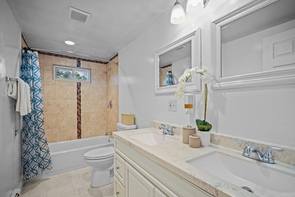 1122 Wood Street Fall River, MA 02721 - Photo 28 of 39 a bathroom with a granite countertop sink a toilet and shower