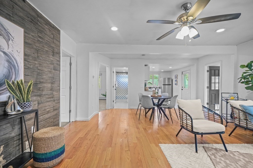 1122 Wood Street Fall River, MA 02721 - Photo 5 of 39 a dining room with furniture and wooden floor a chandelier