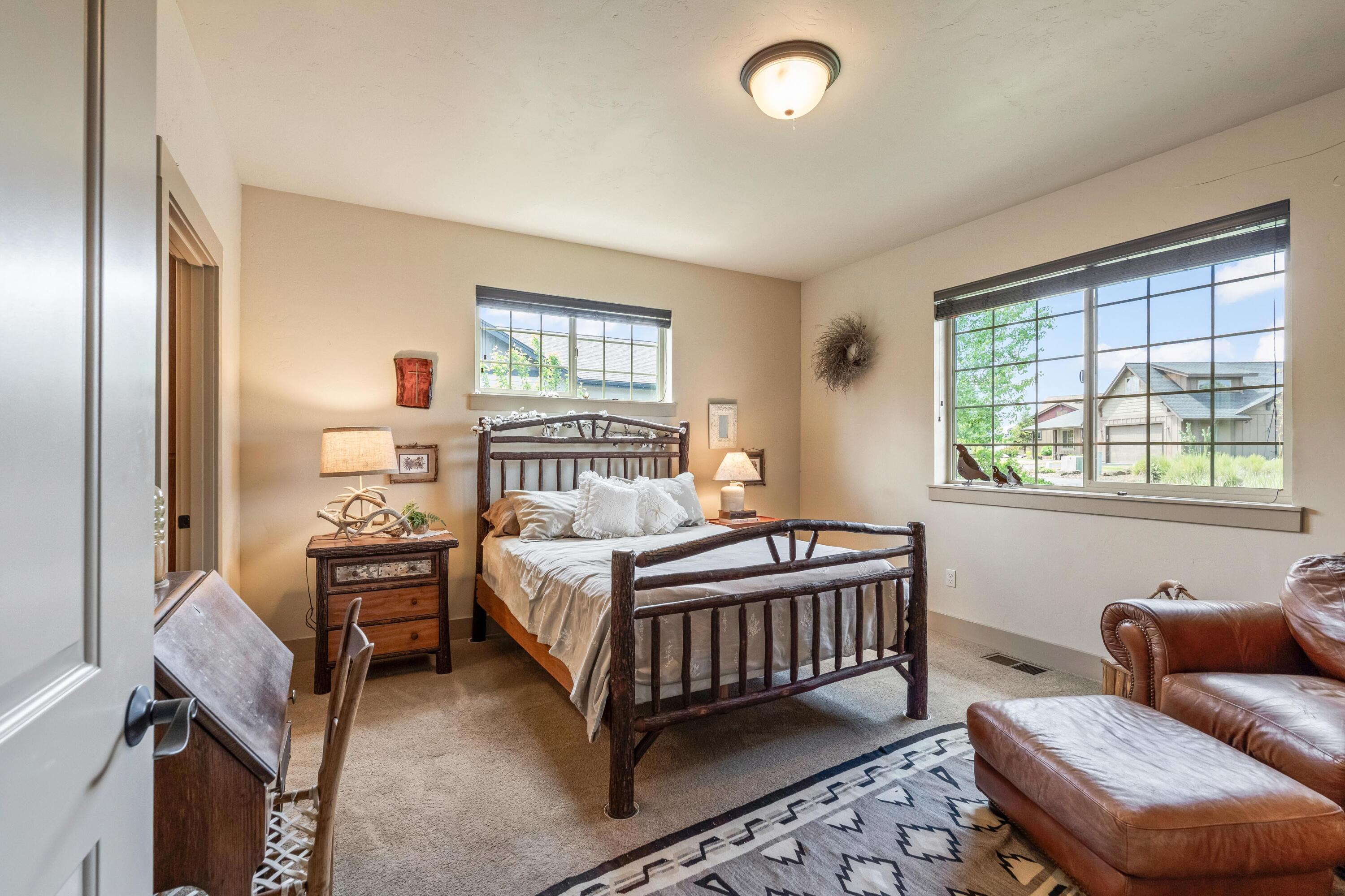 210 Northwest Saddle Ridge Loop Prineville, OR 97754 - Photo 13 of 38 a bedroom with a bed and wooden floor