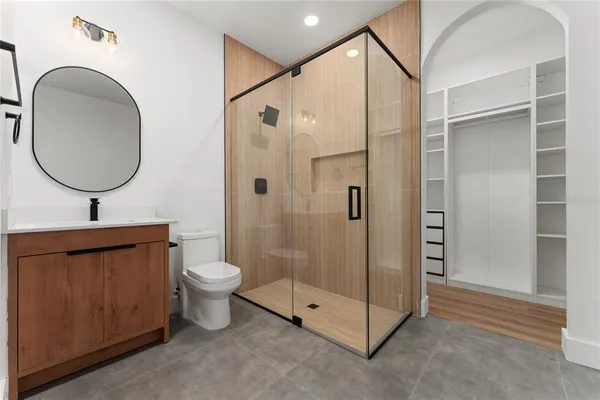 a bathroom with a toilet a sink and a mirror