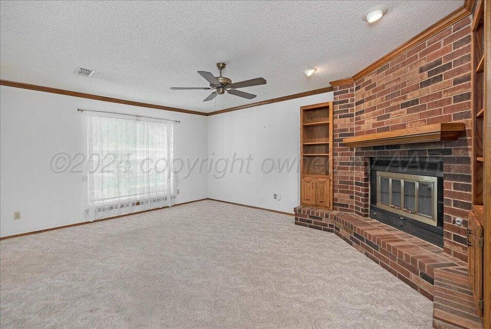 3900 Ozark Trail Amarillo, TX 79109 - Photo 3 of 15 a view of an empty room with a fireplace