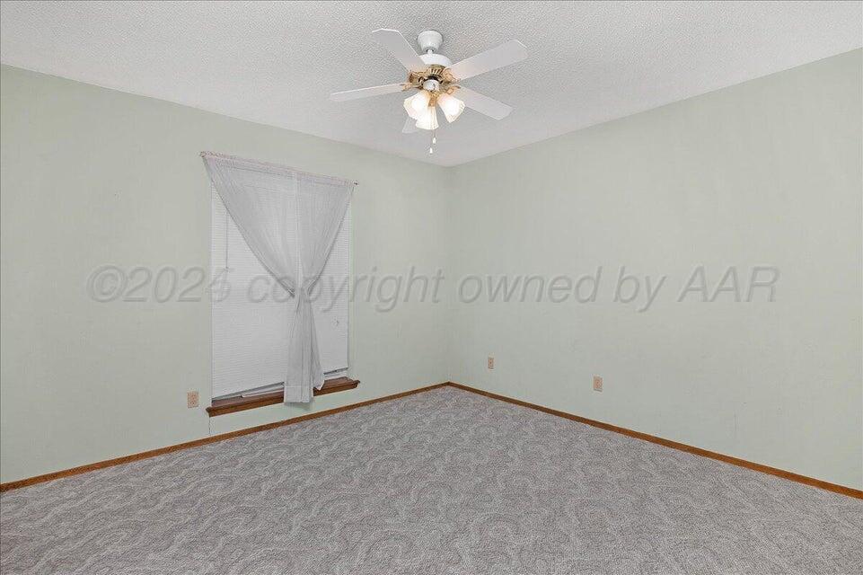 3900 Ozark Trail Amarillo, TX 79109 - Photo 9 of 15 an empty room with fan and windows