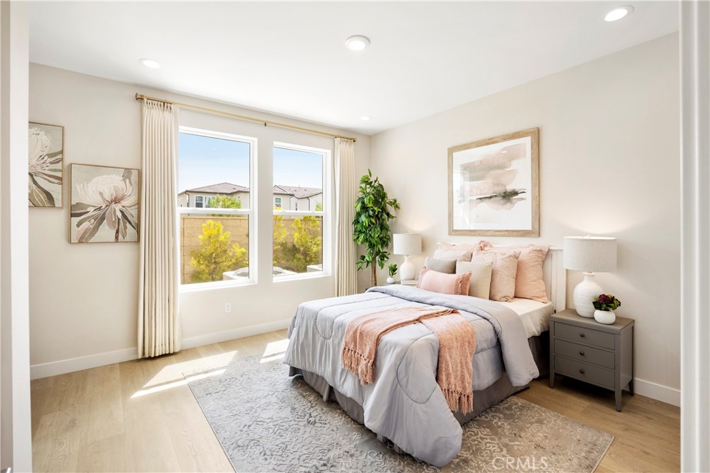 130 Pin Lane Lake Forest, CA 92630 - Photo 17 of 70 a bedroom with a bed lamp and a large window