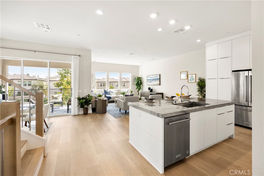 130 Pin Lane Lake Forest, CA 92630 - Photo 27 of 70 a kitchen with stainless steel appliances kitchen island granite countertop a stove and a sink