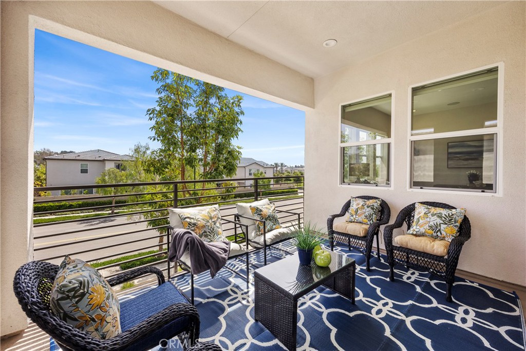 130 Pin Lane Lake Forest, CA 92630 - Photo 35 of 70 a balcony with furniture and a floor to ceiling window