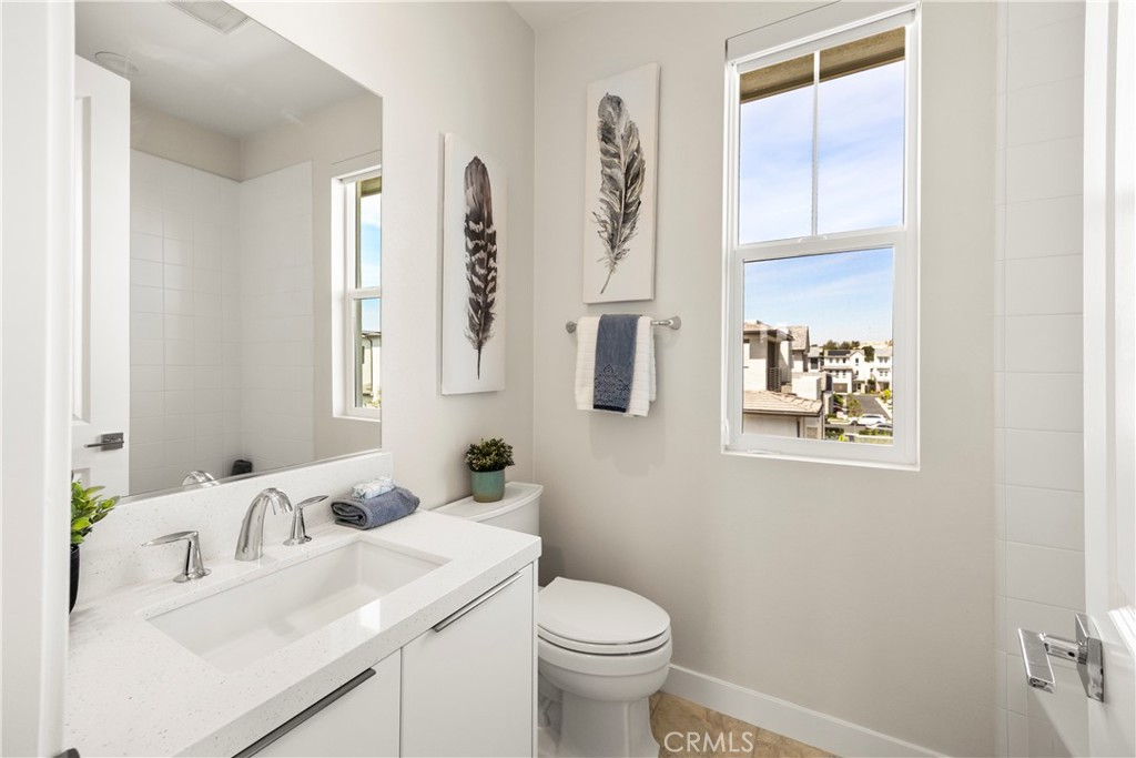 130 Pin Lane Lake Forest, CA 92630 - Photo 46 of 70 a bathroom with a sink a toilet and a mirror