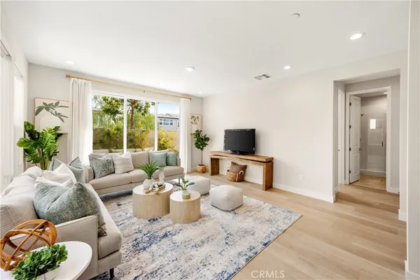 a living room with furniture and wooden floor