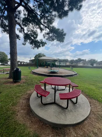 a wooden bench sitting in the middle of a park