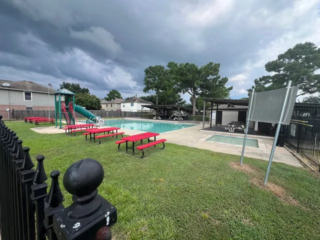 a view of a backyard with sitting area and slide