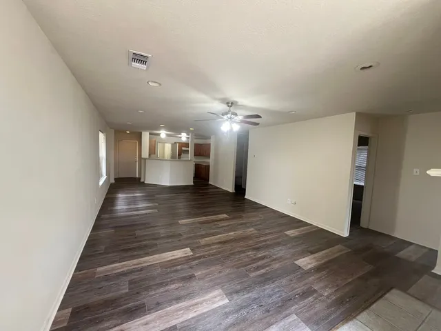 a view of a hallway with wooden floor
