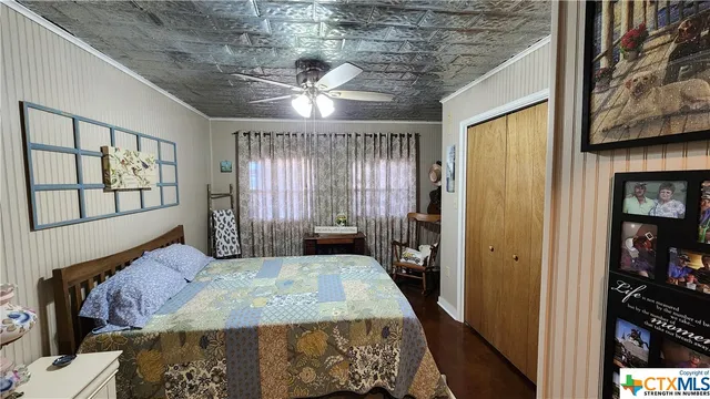 a bed sitting in a bedroom next to a window