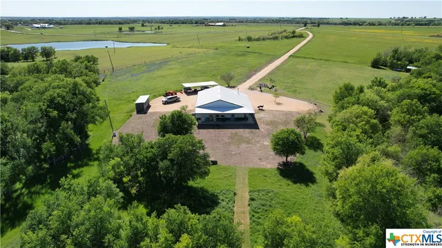 an aerial view of a house with a lake view