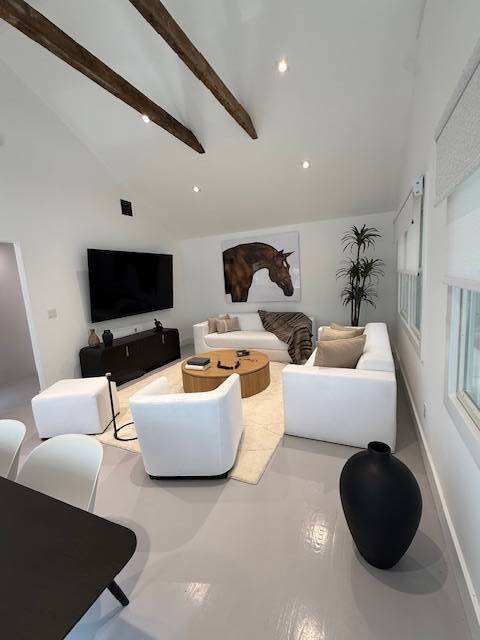 876 A Millstone Road Water Mill, NY 11976 - Photo 2 of 12 a living room with furniture and a flat screen tv