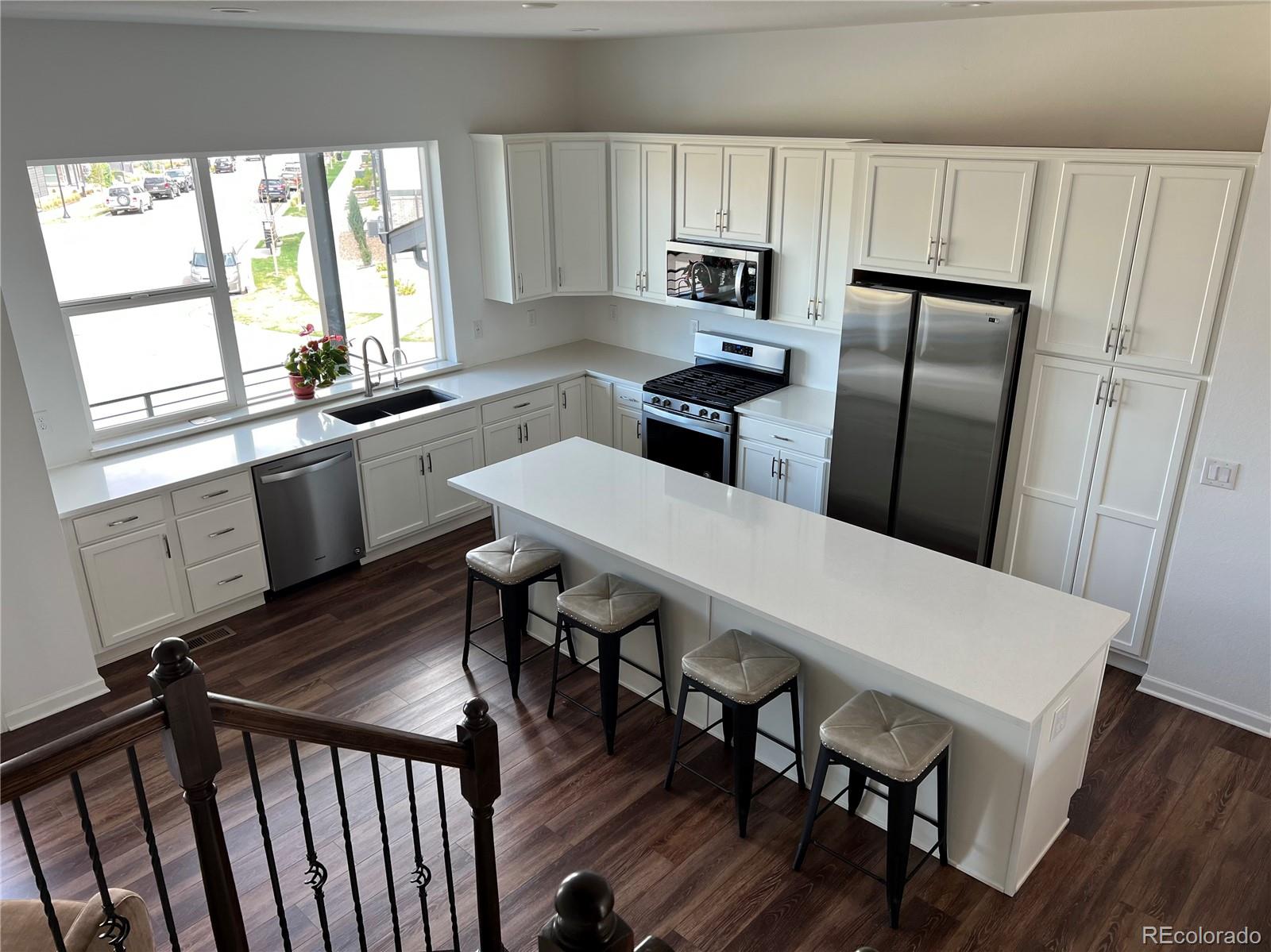 5105 Vivian Street Wheat Ridge, CO 80033 - Photo 11 of 39 a kitchen with a table chairs refrigerator and microwave