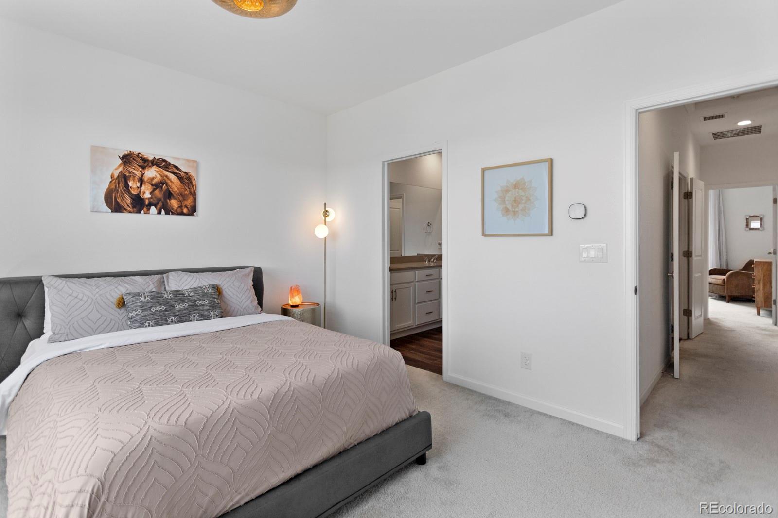 5105 Vivian Street Wheat Ridge, CO 80033 - Photo 24 of 39 a bedroom with a bed and a painting on the wall