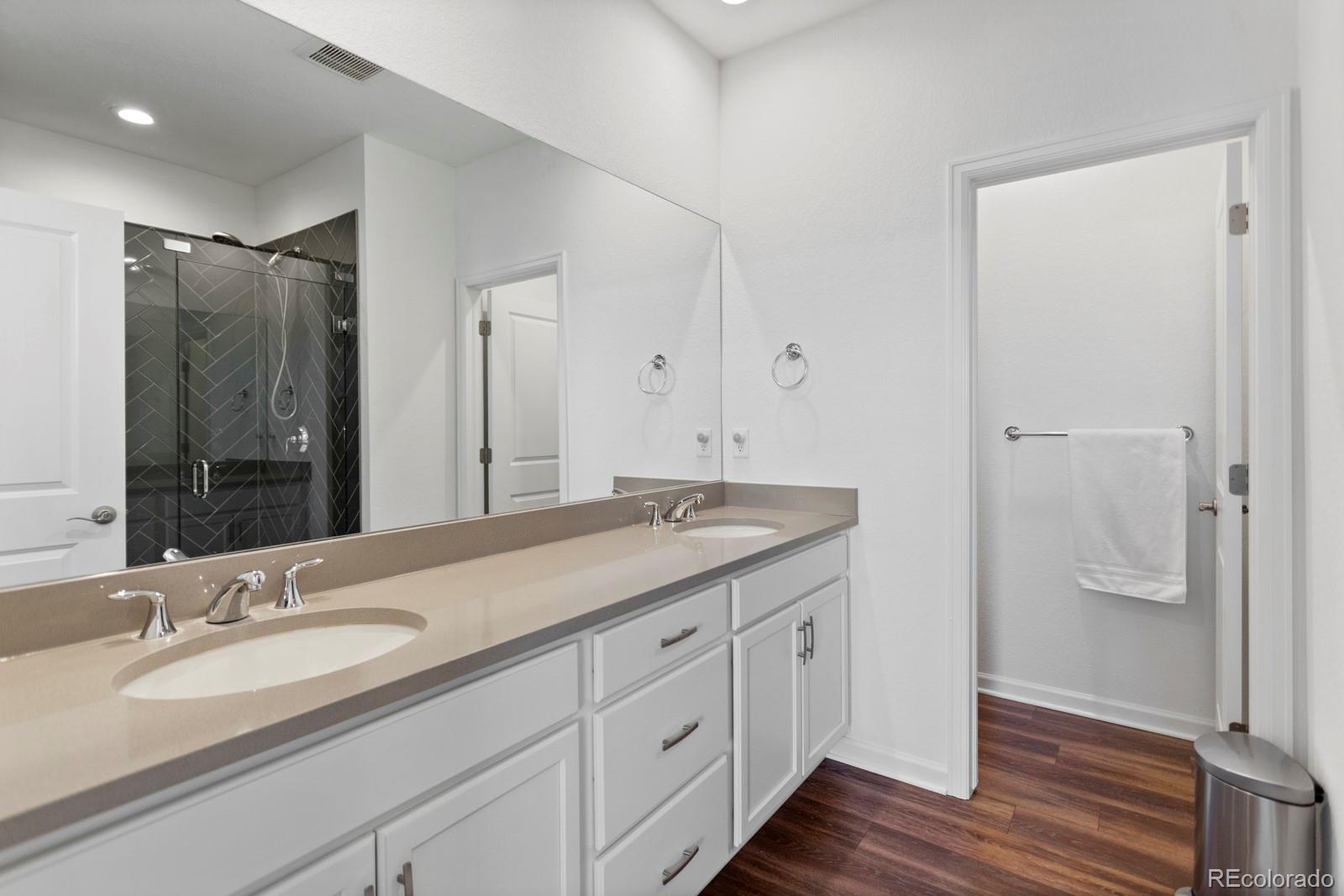 5105 Vivian Street Wheat Ridge, CO 80033 - Photo 25 of 39 a bathroom with a granite countertop sink and a mirror