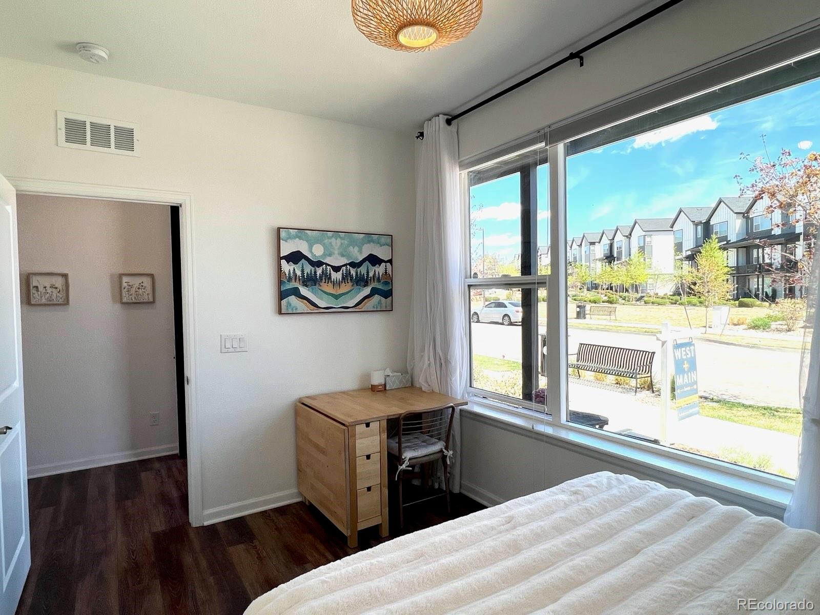 5105 Vivian Street Wheat Ridge, CO 80033 - Photo 28 of 39 a bedroom with a bed and a large window with outer view