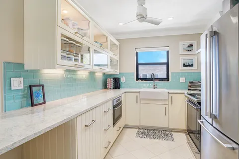 a kitchen with a sink stove and cabinets