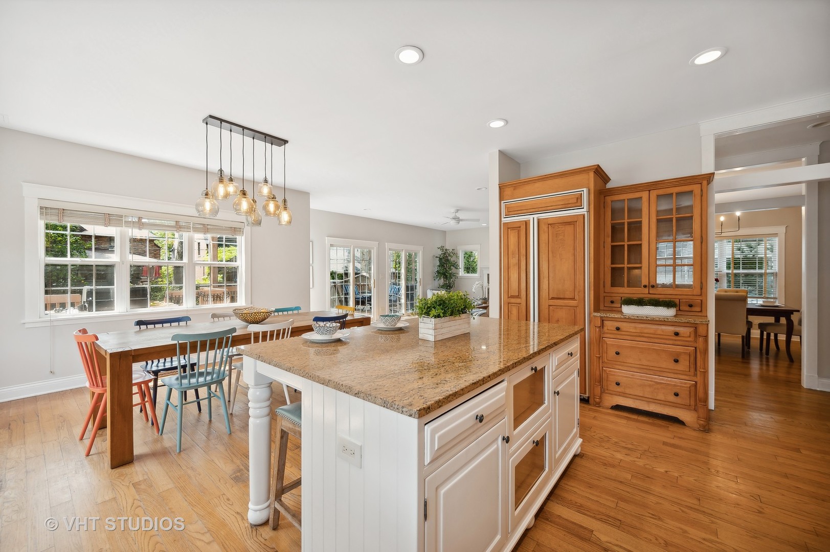 724 Juniper Road Glenview, IL 60025 - Photo 7 of 27 a kitchen that has a lot of cabinets in it and wooden floors