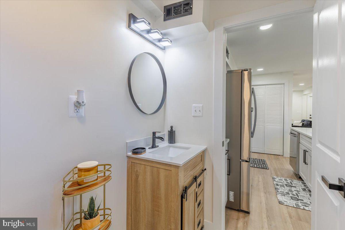 4702 Meade Street Northeast Washington, DC 20019 - Photo 17 of 28 a bathroom with a sink and a mirror