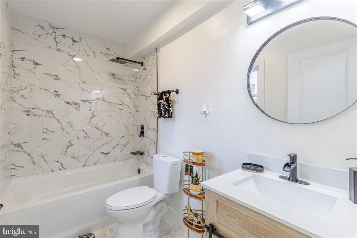 4702 Meade Street Northeast Washington, DC 20019 - Photo 18 of 28 a bathroom with a sink a toilet and a mirror