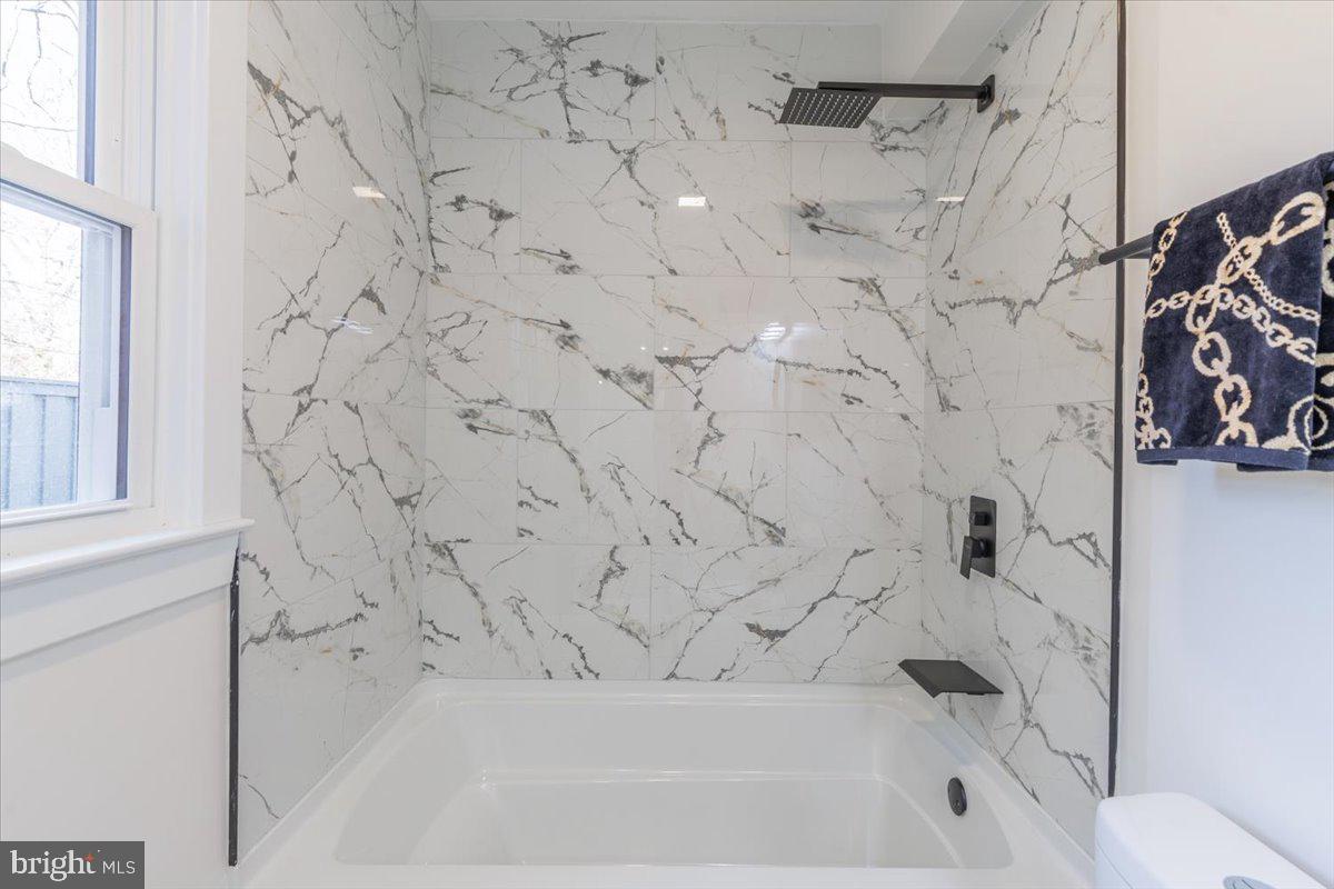 4702 Meade Street Northeast Washington, DC 20019 - Photo 19 of 28 a bathroom with a bathtub and shower