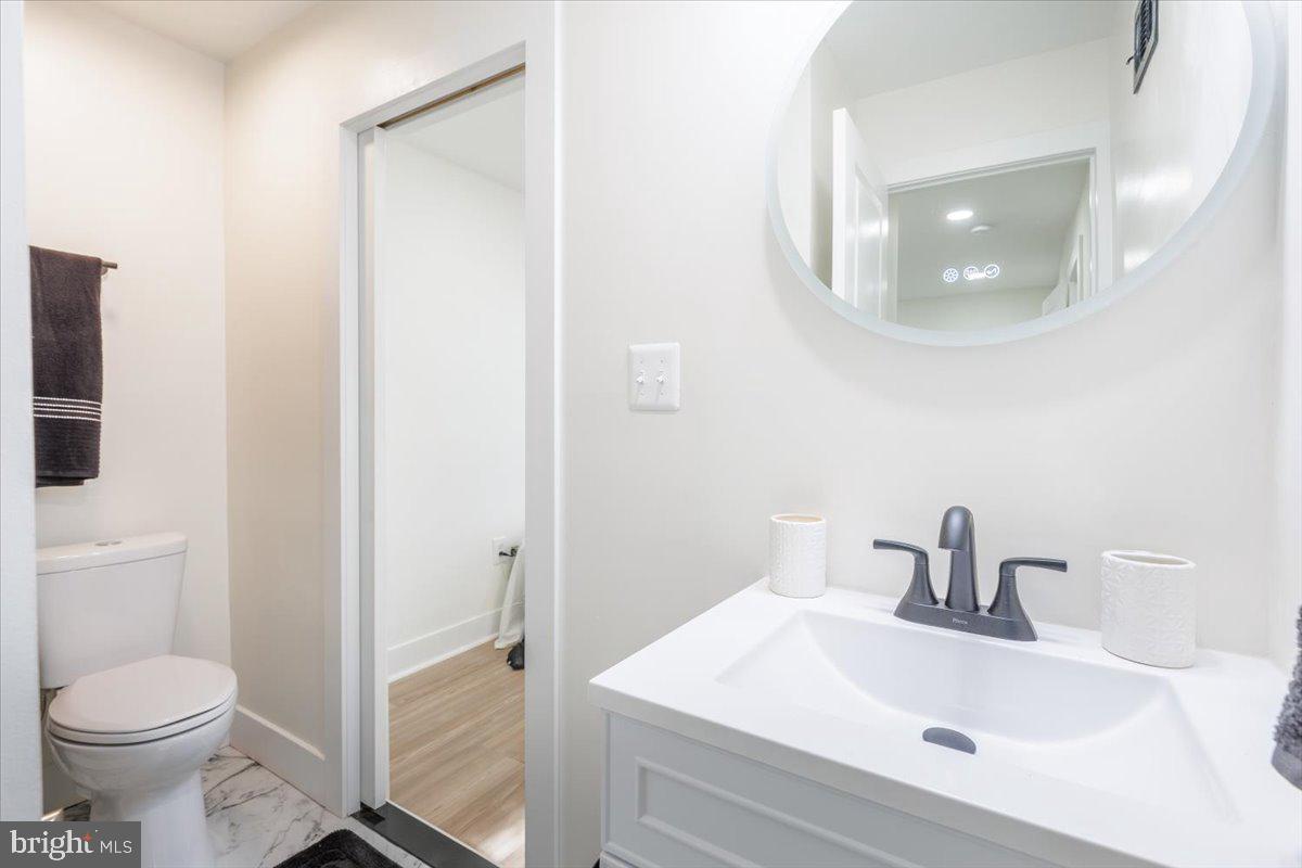 4702 Meade Street Northeast Washington, DC 20019 - Photo 22 of 28 a bathroom with a sink toilet and vanity