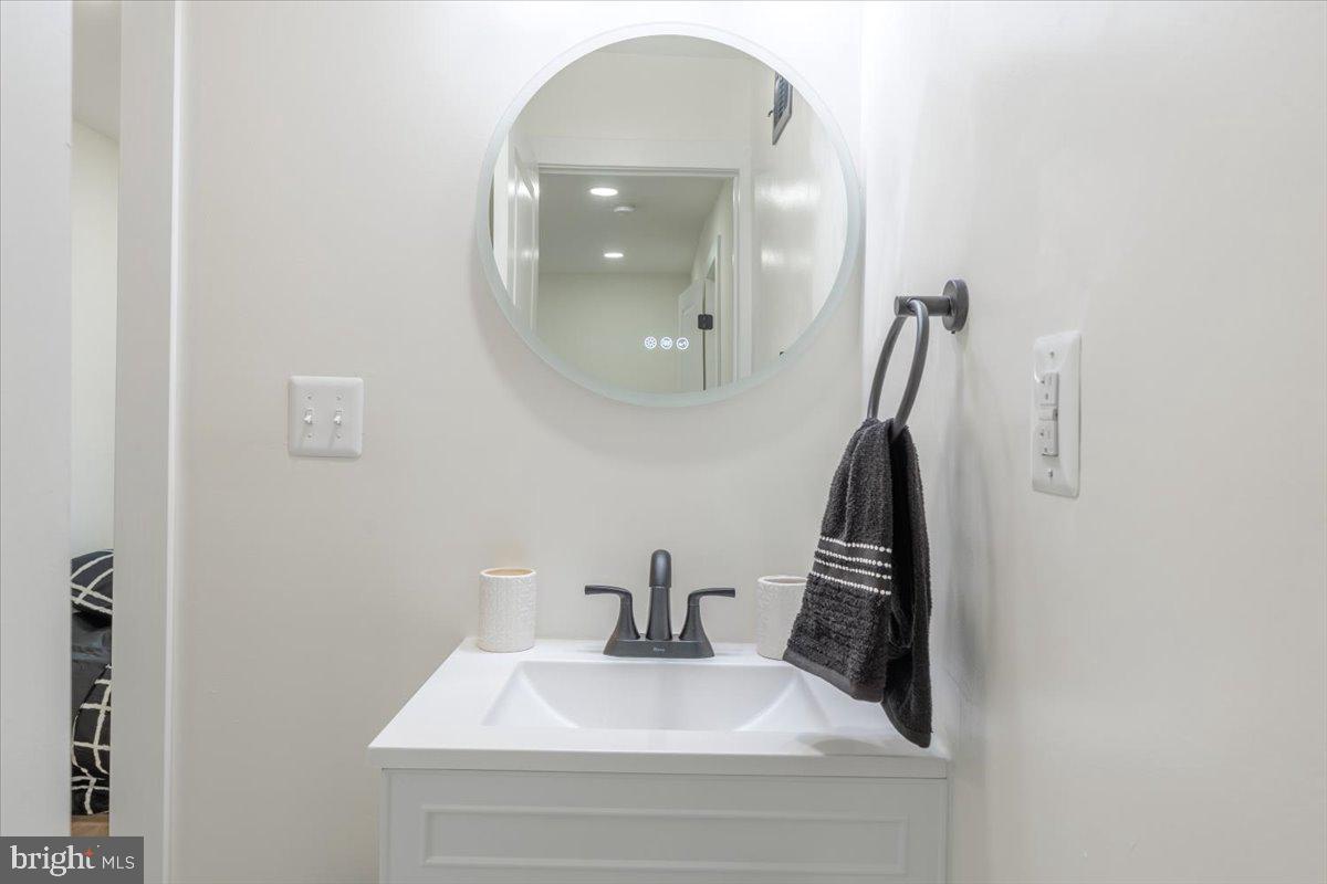 4702 Meade Street Northeast Washington, DC 20019 - Photo 23 of 28 a bathroom with a sink and a mirror