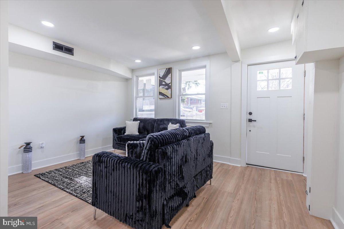 4702 Meade Street Northeast Washington, DC 20019 - Photo 7 of 28 a living room with furniture and a wooden floor