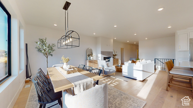 657 North Heritage Street, Unit 9 Mapleton, UT 84664 - Photo 7 of 10 Dining area featuring light wood finished floors, recessed lighting, a chandelier, and a fireplace