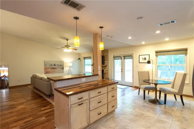 a view of deck with furniture and trees around
