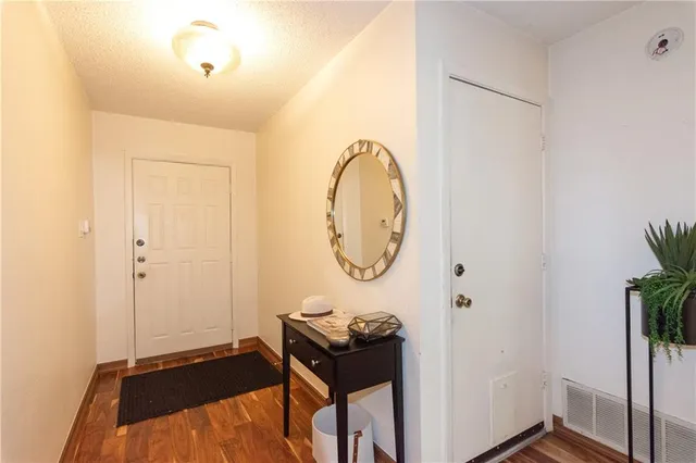 a bedroom with a bed and a potted plant