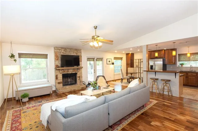 a living room with furniture fireplace and flat screen tv