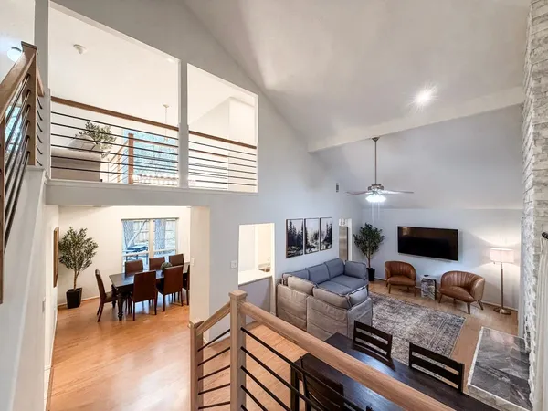 a living room with furniture a dining table and a piano