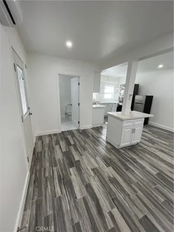 a view of an empty room and wooden floor