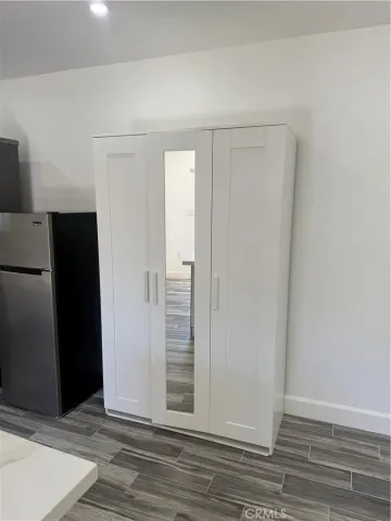 an empty room with wooden floor and closet