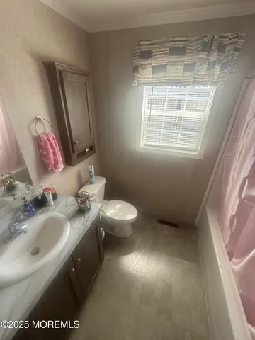a bathroom with a sink toilet and mirror
