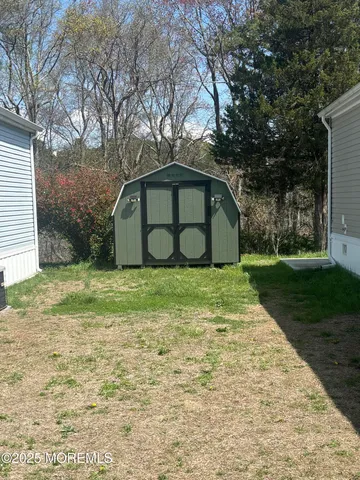 a view of a wooden house with a yard