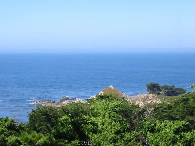 an aerial view of a ocean with beach