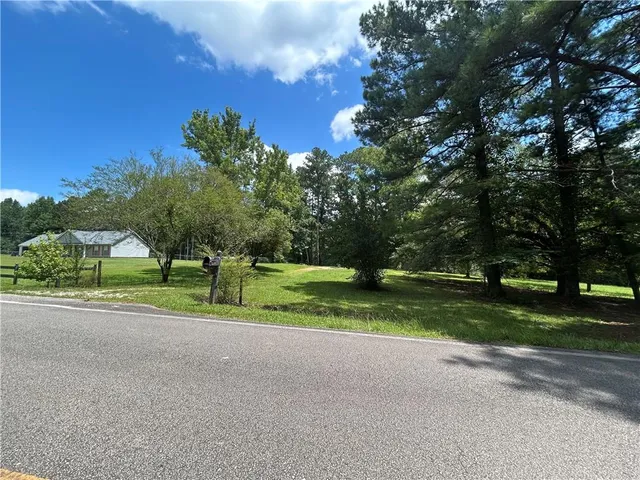 a view of a green yard with a house