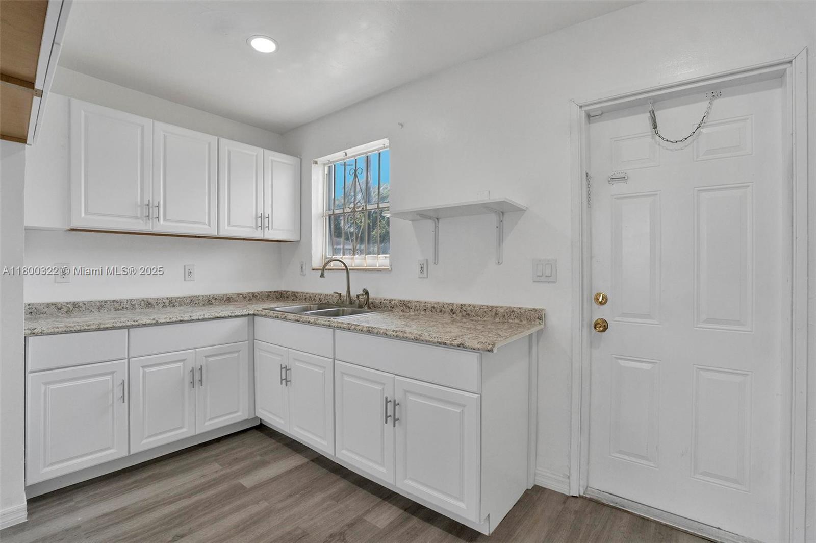 3051 Northwest 77th Street Miami, FL 33147 - Photo 20 of 44 a kitchen with sink cabinets and window