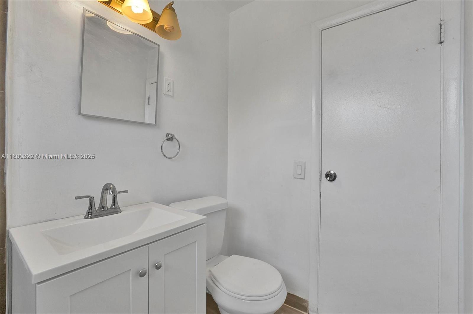 3051 Northwest 77th Street Miami, FL 33147 - Photo 22 of 44 a bathroom with a sink a toilet and mirror