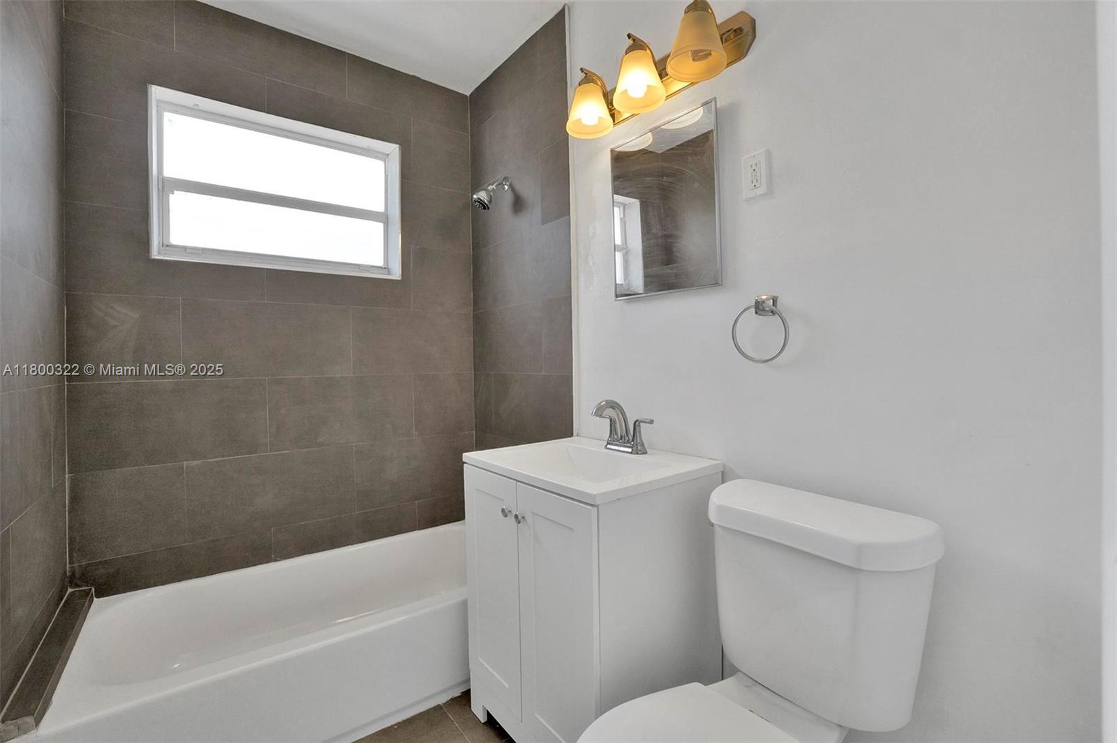 3051 Northwest 77th Street Miami, FL 33147 - Photo 27 of 44 a bathroom with a toilet a sink and bathtub