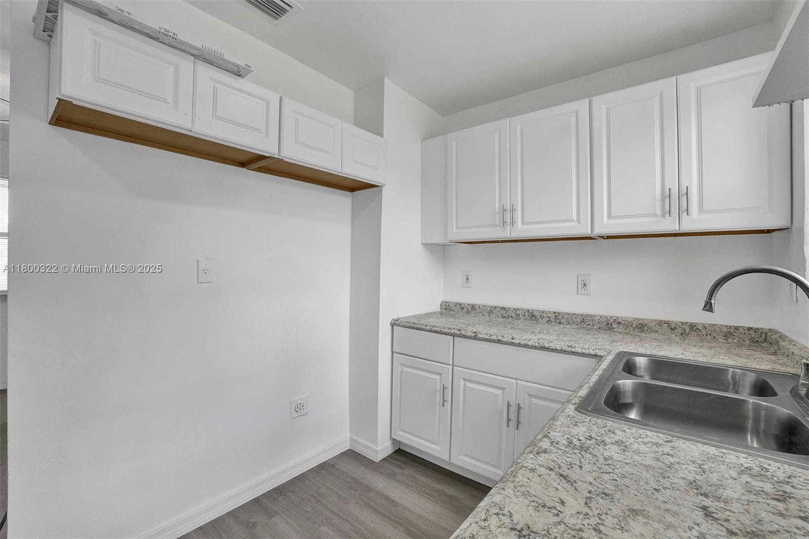 3051 Northwest 77th Street Miami, FL 33147 - Photo 29 of 44 a kitchen with stainless steel appliances granite countertop a sink a stove and cabinets