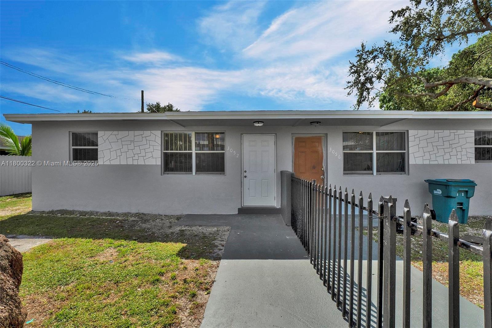3051 Northwest 77th Street Miami, FL 33147 - Photo 3 of 44 a front view of a house with a yard