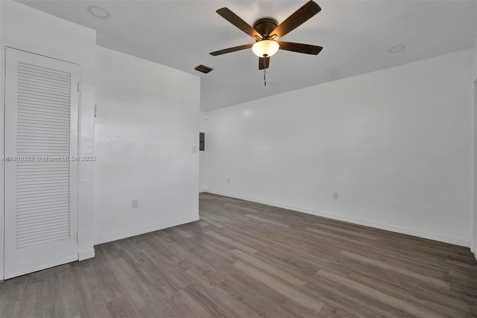3051 Northwest 77th Street Miami, FL 33147 - Photo 31 of 44 an empty room with wooden floor and a ceiling fan